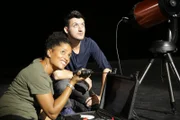 MANCHESTER, U.K. - Volunteers Will Watremez, right, and Sian Proctor operate a telescope and lumens meter to detect changes in light frequency.
