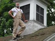 Jay stands tall, waiting in anticipation to open the slats and check out the bell at the top of the school building.