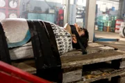 Rajesh (Parbet Chugh) wird entführt und wacht gefesselt in einer Autowerkstatt unter einer Hebebühne auf.