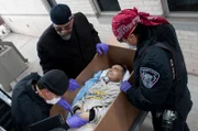 El Paso, TX: Officers searching a coffin and a corpse for contraband. Smugglers will use any method available to transport illegal goods across the border, even hiding the contraband inside a dead corpse or coffin.