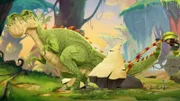 Der Kiesel verfängt sich in einer Schuppe von Giganto. Doch vielleicht ist der Schatz beim mächtigsten Lebewesen von Dinosaurier-Land am besten aufgehoben.