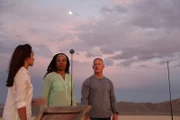BLACK ROCK DESERT, NEV. - Volunteers; James Fitzsimmons, Joy Ng and CaTamira Babino, stand next to scale model of the earth.