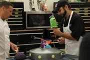 Ralph and Joe adding sculpted creatures to the cake.