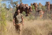 Hazen Audel wandert durch rote Felsenberge in der australischen Wüste.