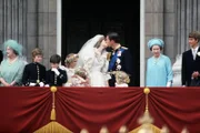 Prince Charles, Prince of Wales, kisses Diana, Princess of Wales on the balcony of Buckingham Palace following their wedding in London, England.