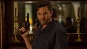 Eric brandishes his gun.