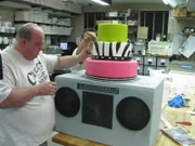 Working on the 80's Rock Band cake , as seen in 'Cake Boss' series 3 featured in 312.