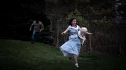 Girl runs from masked man.