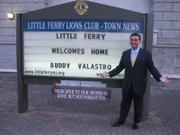 Buddy stands in front of his welcome sign , as seen in 'Cake Boss' series 3 featured in episode 312.