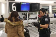 Officer Valentin checks passengers ID. (National Geographic/Lucky 8 TV)