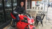 Alessandro Acquisti, Ph.D., Professor für Informationstechnologie und öffentliche Politik am Heinz College der Carnegie Mellon University, sitzt auf seinem Motorrad.