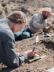 Close upside view of Victoria Long digging for bones