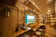 Working in his idea of movement to his tiny house, Davis Richardson created one long bar that includes a desk for his laptop, a place to eat, counter space and a pantry way at the end as seen on Tiny House, Big Living.