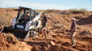 Andre Lujan, Matthew Harrell, and Kenneth Kowalsk talking at the dig site.
