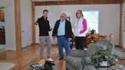 David Bromstad wears a dark sweater and explains the winners during the tour of one possible house