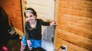 Natalia Barnett smiling in front of door
