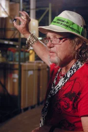 Laurence holding a natural gem found in a wooden crate