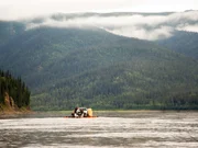 Joey Zuray and Zeb (Joey's cousin) driving away on a boat and a raft with a pick up truck on the Yukon River.