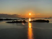 Die "Grand Lady" vor Stockholm in Schweden. Lotsen-Einfahrt in die Schärengärten nach Stockholm. Morgenstimmung mit aufgehender Sonne.
