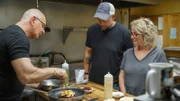 Chef Robert Irvine shows Leah Fogle & Chris Fogle, Leah's Korner Kafe, how to make the entrées from the new menu at Leah's Korner Kafe in Coleman, MI, as seen on Restaurant: Impossible Season 20.