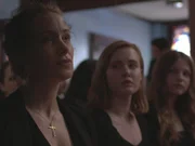Blanche Taylor Moore at husband?s funeral, daughters sitting next to her.