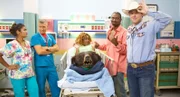 A woman with a bear head in her lap at the hospital.