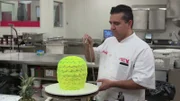 Buddy sprays the pineapple cake to give it texture and the right color.