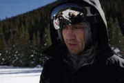 Tim Kennedy in his ski gear in the snowy mountains.
