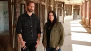 Hosts Nick Groff and Katrina Weidman stand in decrepit hallway with lots of doors.