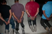 Brownsville, TX, USA: Looking down on apprehended and handcuffed men on their knees.