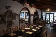 To add character, the design team added a new chandelier above the back part of the restaurant, as seen on Food Network's Restaurant: Impossible, Season 12.
