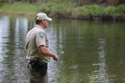 Warden Morgan Inman looking over water.