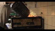 Hot coals poured into a grill.