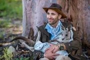 Coyote Peterson holding baby kangaroo.