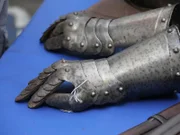 A pair of gauntlets sitting on the appraisal table.