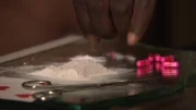 JJ cutting down heroin with sleeping pills to increase the volume so that he can make more money.