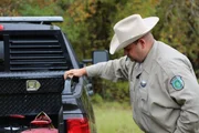 Warden Justin Eddins next to the warden truck.