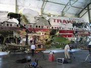 Reconstructed TWA plane at NTSB hangar. Wider view of the 93-foot forward section of the plane fuselage. This reconstructed TWA plane is now used to train air-crash investigators.