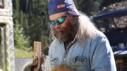 Keith Paradis screws a piece of metal with a drill wearing protective gloves and glasses