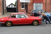 Portsmouth - The Martin family help Tim Shaw to push the car out of the house.