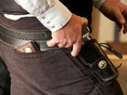 During a quick draw competition, an eager hand grasps the handle of a classic revolver.