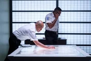 KNKT Investigators Ray Nurcahyo (played by Von Flores) reviews maps concerning the flightpath of Trigana Service Flight 267, while KNKT Investigator Ony Wibowo (played by Josh Barilko) receives a crucial call that might help them.