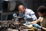 Investigator Dennis Jones (played by Glen Michael Grant) works hard to find any clues that can be gleaned from the wreckage of LAM Mozambique Flight 470, while the Lead Namibian Investigator (played by Jamaal Grant) takes notes.
