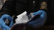 CBP-Beamter Zuniga hält ein Paket mit Kokain in der Hand, nachdem es in einer Sendung auf dem JFK International Airport in New York entdeckt worden war. (National Geographic)