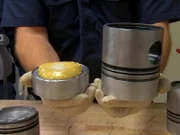 An engine piston head that has been taken apart showing a bag of heroin that was concealed inside.