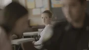 A dramatization of Samantha Mann, friend of the victim, in a classroom.