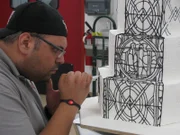 Frankie Amato pipes onto the stained glass cake.