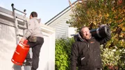 Sascha seals the roof of a garage near Bielefeld with his work colleagues.