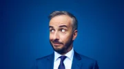 Jan Böhmermann im blauen Anzug vor blauem Hintergrund.