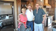 Winners and a friends pose during the three months later party, by the kitchen at the hero house